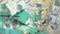 Animation of ticking clock against team of diverse surgeons performing surgery at hospital
