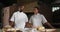 Animation of two diverse male and female bakers smiling at camera in bakery