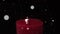 Animation of white spots of light floating over lit red candle on black background