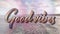 Animation of the words good vibes written in pink letters over cloudy blue sky and sea