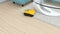 Animation of a yellow robotic vacuum cleaner in living room