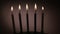 Animation of yellow and white zigzag lines over four lit birthday cake candles