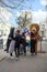 Animators in a lion, zebra and penguin costume from the cartoon Madagascar are photographed with girls on the street