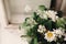 Anise and chamomile bouquet in light at rustic white wooden wind