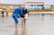 Ankara/Turkey- April 06 2019: Old Turkish couple pick salt crystal under the water in Salt Lake Turkish: Tuz Golu