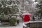 Ankara/Turkey-December 06 2019: Girl in red coat under red umbrella in winter