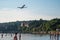 Ankaran, Slovenia - June 26, 2020: Airplane flying dangerously close to a beach full of people