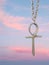 An Ankh or key of life in silver and in the background a beautiful sky.