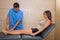 Ankle mobilization therapy of doctor man to patient woman