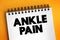 Ankle pain text on notepad, medical concept background