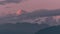 Annapurna mountain range at sunset among moving clouds in the Himalayas in Nepal. Timelapse