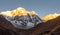 Annapurna south mountain during sunrise golden hour with clear blue sky being hit by first sunshine