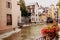 Annecy city water channel with red flowers and old buildings