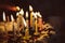 anniversary cake with hand burning candles in dark