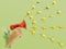 Announce minimal concept. Child handheld megaphone with yellow roses heads spread out in the air. Green background