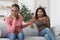 Annoyed black woman showing stop gesture to her scolding girlfriend