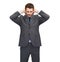 Annoyed businessman covering ears with his hands