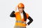 Annoyed and disappointed female asian chief engineer scolding construction workers making stupid mistake, tap helmet and