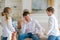 An annoyed father sitting on sofa at home in living room distracted from noise