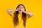 Annoyed ginger woman screaming with shut ears on yellow background. Lady block annoying sounds, music, shouts or noise