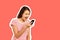 Annoyed hysterical young woman screams into mobile phone, the girl is displeased with the conversation. emotional girl Magazine