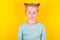 Annoyed, sad, upset kids emotion. Cute upset little girl standing isolated over yellow background