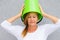Annoyed woman with bucket on head