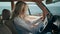 Annoyed woman calling phone sitting car close up. Girl hitting steering wheel