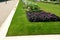 Annual flowerbed in a formal park of rectangles in the lawn. perfect connected flower bed at the pedestrian zone with benches