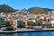 Ano Syros town, Syros island, Greece, St George catholic cathedral above, colorful houses, summer sun, trucks in port of