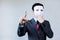 Anonymous businessman in mask hiding himself touching on virtual screen