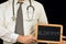 Anonymous doctor holding a school slate on which is written Alzheimer