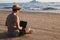 Anonymous freelancer using laptop near sea