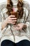 Anonymous girl holding glass of hot chocolate with red straws