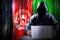 Anonymous hooded hacker, flag of Afghanistan, binary code - cyber attack concept