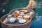 anonymous male traveler holding food tray on water