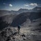 Anonymous mountain climber admiring view of mountains