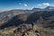 Anonymous mountain climber admiring view of mountains