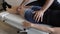 Anonymous osteopath checking hip and knee of woman lying on stretcher