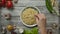 Anonymous person salting noodles over table