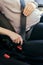 Anonymous pregnant woman wear safety belt in the car