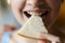 Anonymous teenage girl eating fresh cheese slice