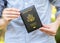 Anonymous unrecognizable man holding a USA passport United States of America passport cover in hands, closeup, one person. US