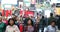 Anonymous urban crowd of commuters, unrecognizable tourists  walking in Manhattan, NYC. Times Square. Blurry Background. Traffic