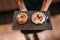 Anonymous waiter serving donuts in cafe