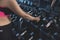 An anonymous woman picks up a pair of 2.5 kg weights from the dumbbell rack