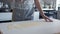 Anonymous Woman, Sprinkling Flour onto Thin Pasta Dough at home. Moving shot