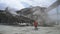 Anonymous worker watching conveyor belt in quarry