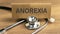 ANOREXIA word wrote on brown label with stethoscope