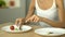 Anorexic girl eating small portion of vegetables, weight loss drugs for dessert